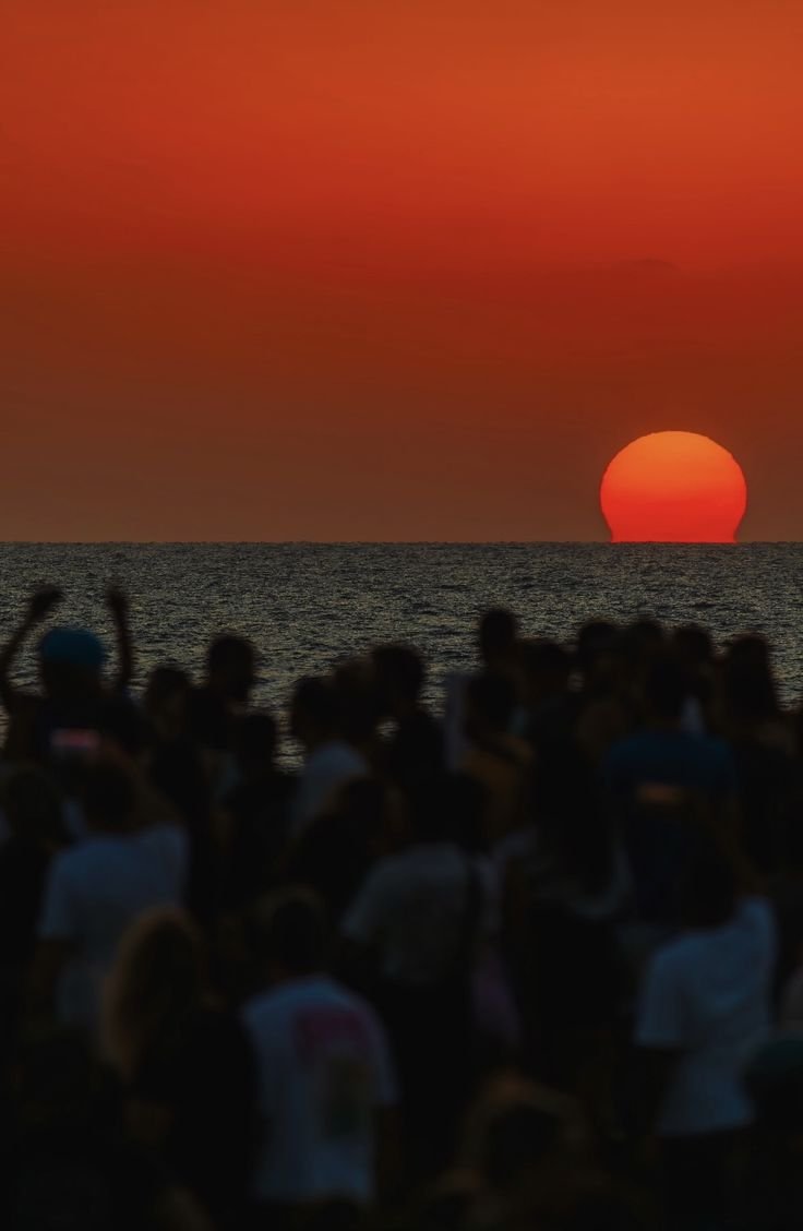 Crowd watching the sunset on the beach at Casa Costa